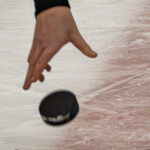 Hand and hockey puck